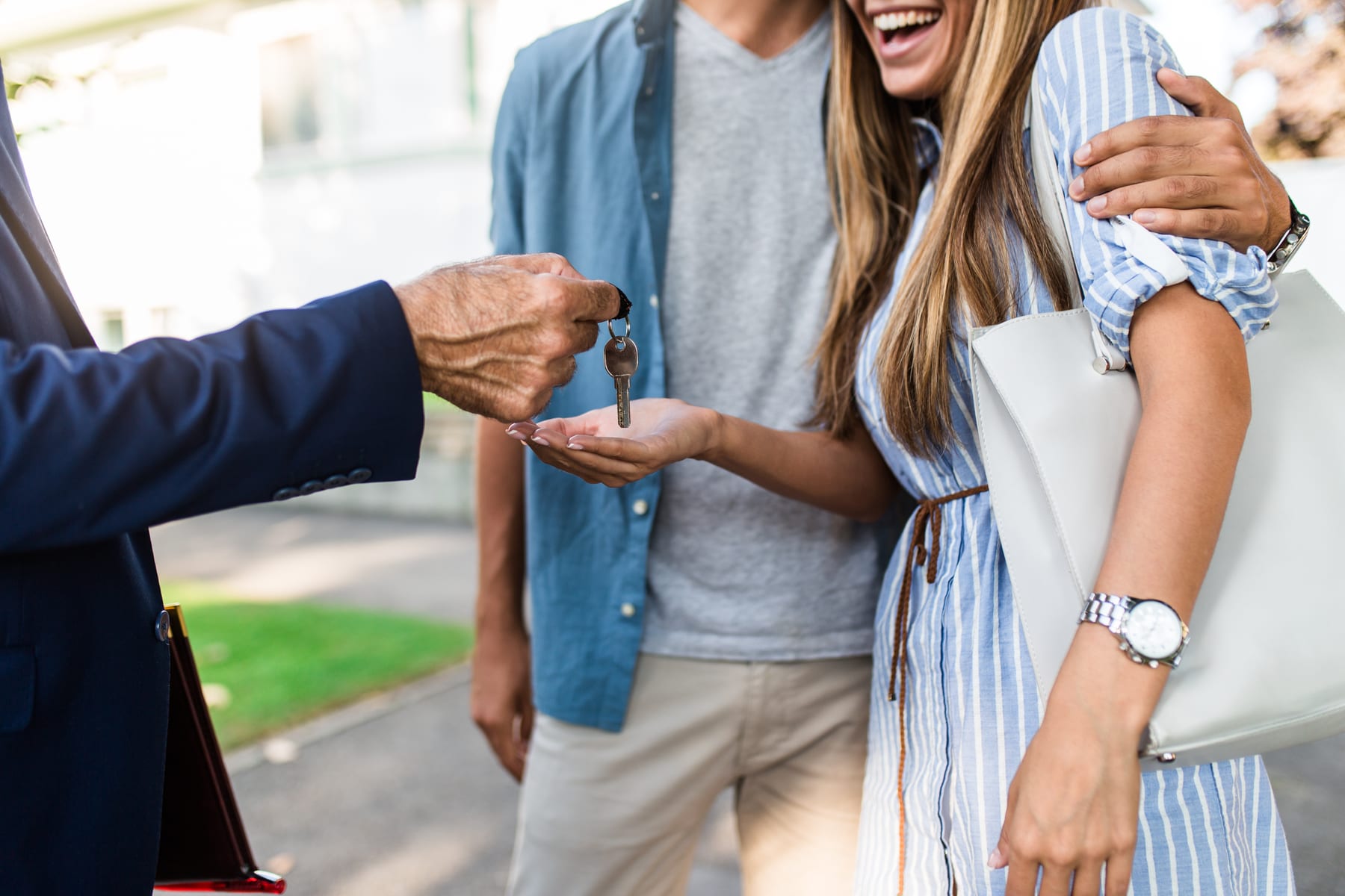 couple receiving house keys from agent